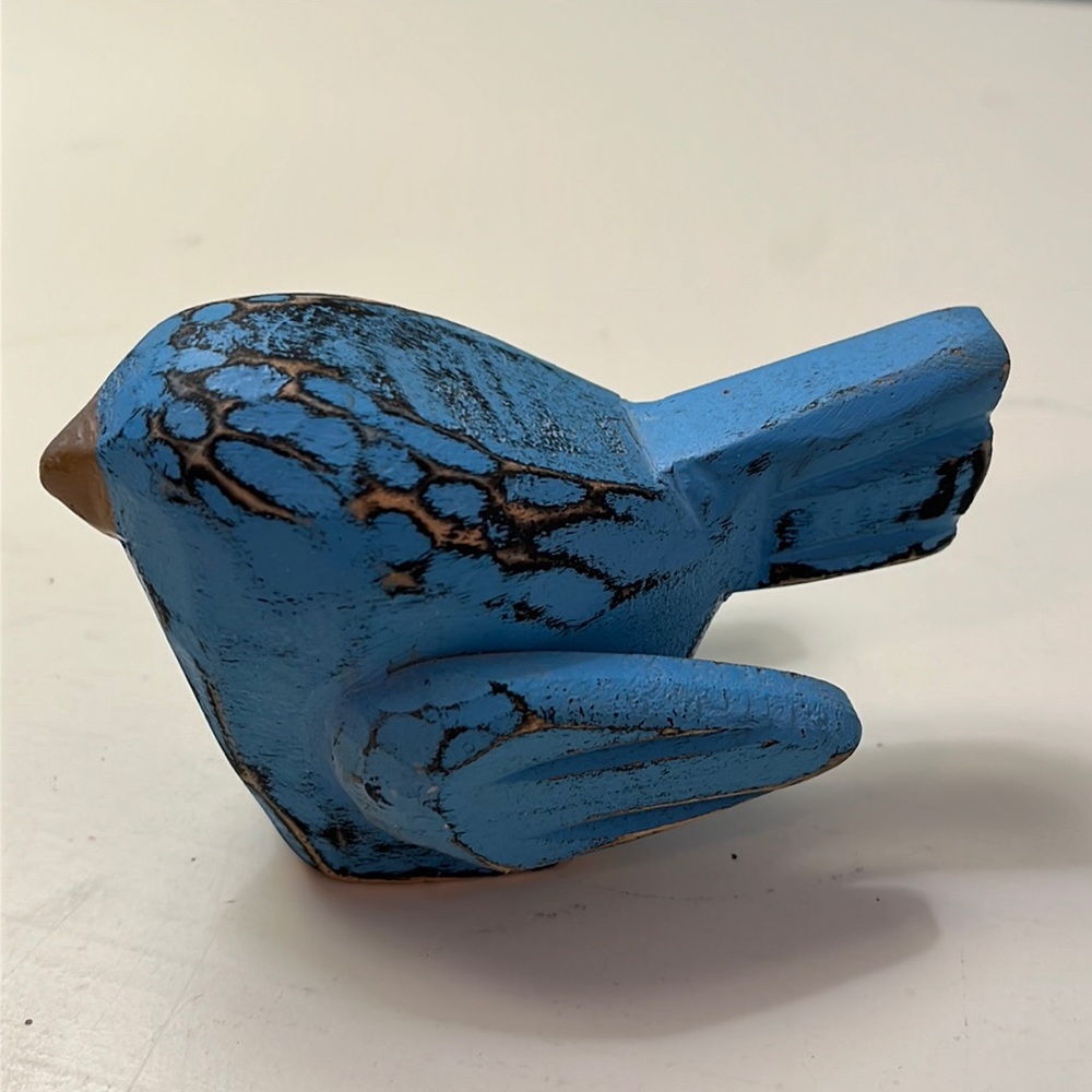 Small blue carved bird.